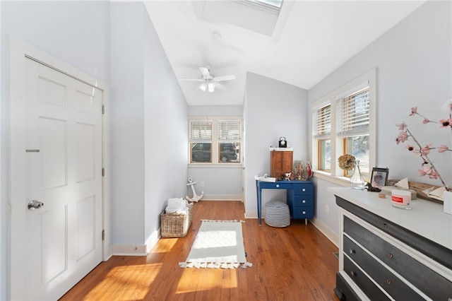 bedroom featuring vaulted ceiling, multiple windows, and light wood-style flooring