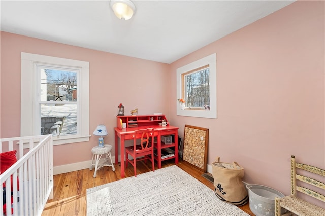 interior space with baseboards and wood finished floors