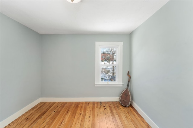 empty room with light wood-type flooring and baseboards