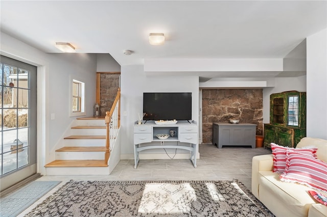 living room featuring stairway