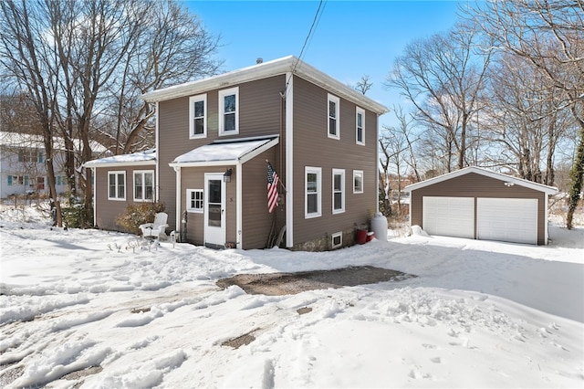 view of front of home featuring a garage and an outbuilding