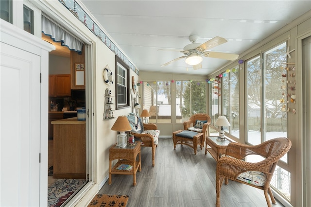 sunroom featuring ceiling fan