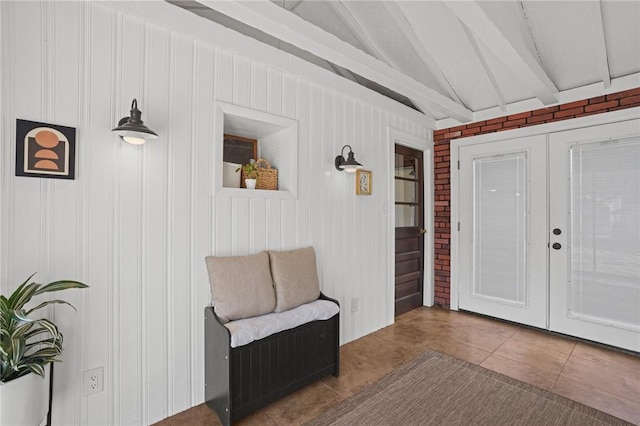 interior space featuring tile patterned flooring and vaulted ceiling with beams