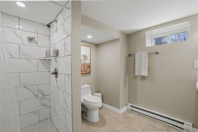 bathroom featuring baseboards, tiled shower, baseboard heating, and toilet