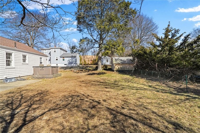 view of yard featuring central AC unit and fence