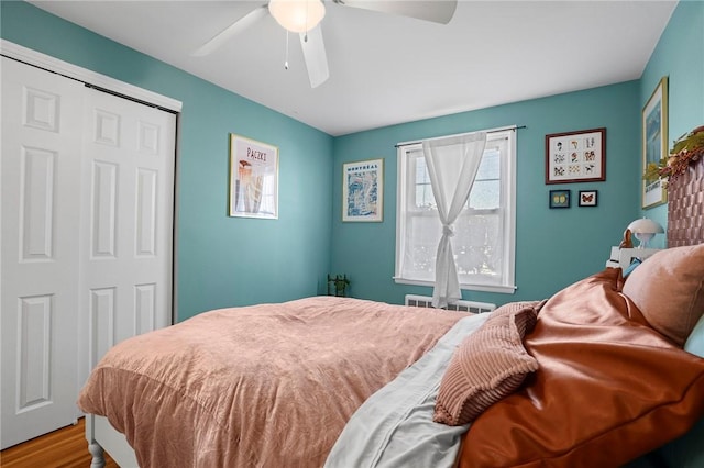 bedroom featuring a closet, a ceiling fan, and wood finished floors