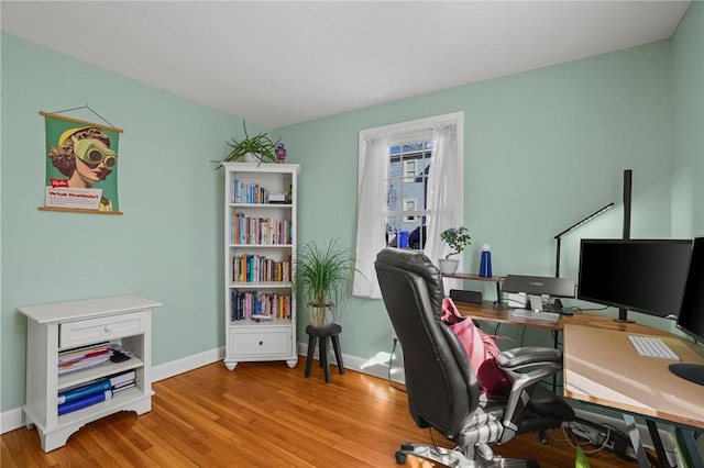 office space with wood finished floors and baseboards