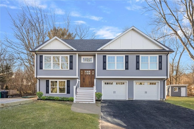 raised ranch with a garage and a front lawn