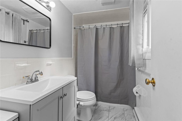 bathroom featuring toilet, tile walls, vanity, curtained shower, and a baseboard heating unit