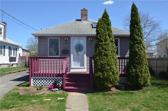 bungalow-style house with a front lawn