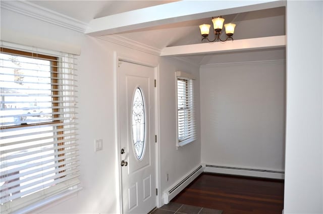 foyer featuring dark hardwood / wood-style flooring, a baseboard heating unit, crown molding, and a chandelier