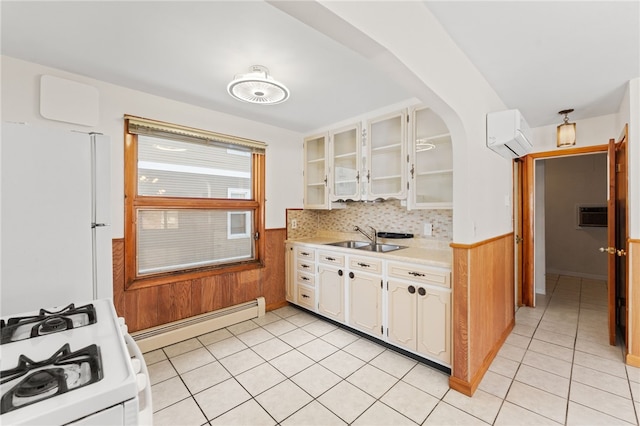 kitchen featuring white appliances, light tile patterned floors, sink, baseboard heating, and a wall mounted AC