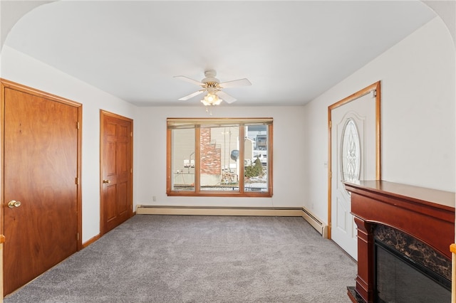 interior space with ceiling fan, light carpet, and a baseboard radiator