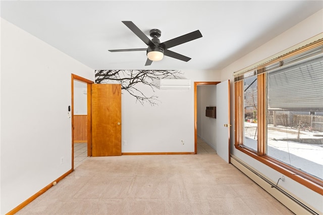 carpeted empty room with an AC wall unit, ceiling fan, and a baseboard heating unit