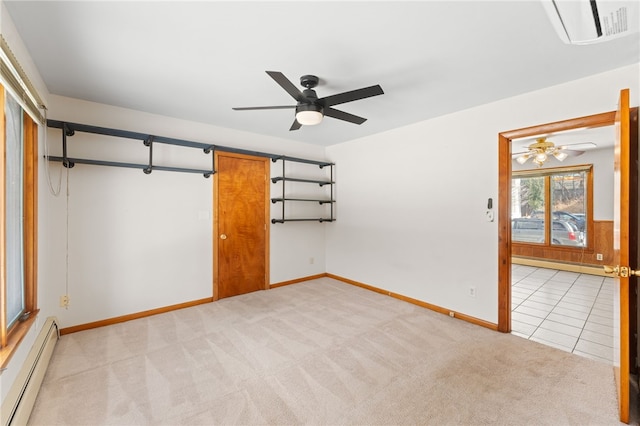 unfurnished room featuring light colored carpet, ceiling fan, and baseboard heating