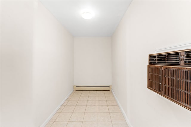 hallway with light tile patterned floors and a baseboard radiator