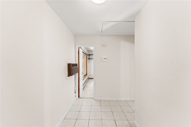 hallway with light tile patterned floors and an AC wall unit