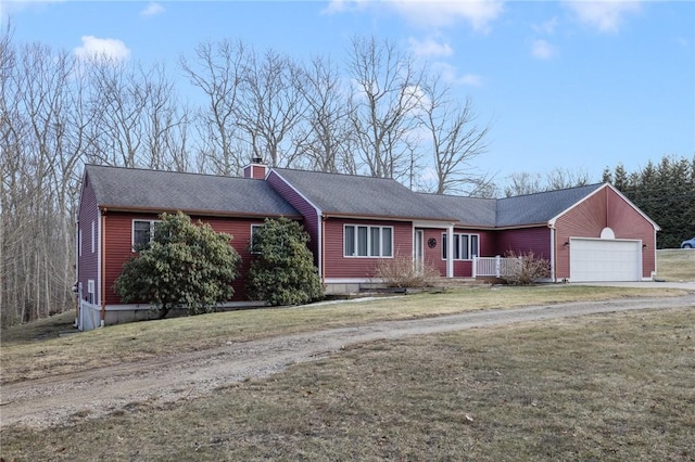 ranch-style home featuring a shingled roof, dirt driveway, a chimney, an attached garage, and a front lawn