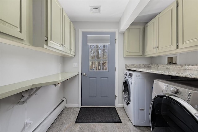 clothes washing area with cabinet space, baseboards, visible vents, and washing machine and clothes dryer