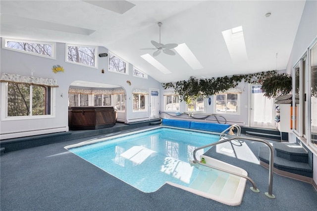 view of pool with an indoor hot tub, a skylight, and a covered pool