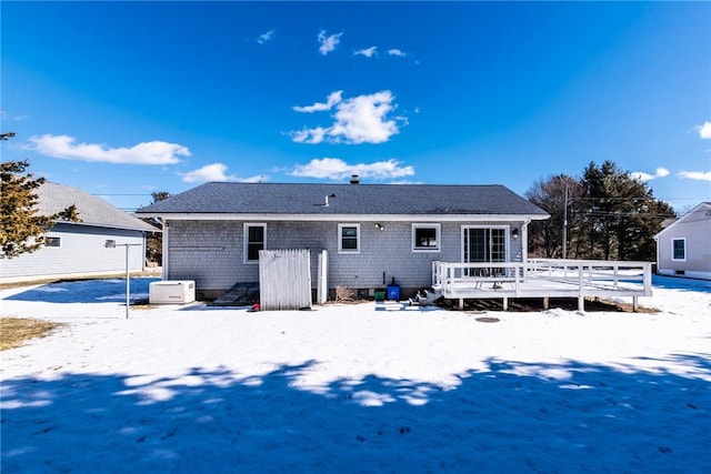 snow covered rear of property featuring a wooden deck