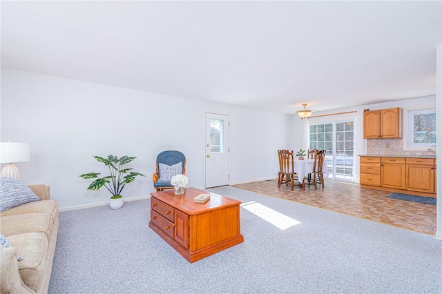 carpeted living room featuring plenty of natural light