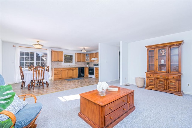 living room with sink and light colored carpet