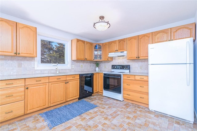 kitchen featuring sink, backsplash, and white appliances