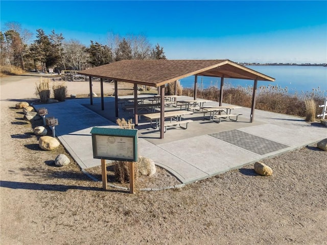 view of property's community with a water view and a gazebo