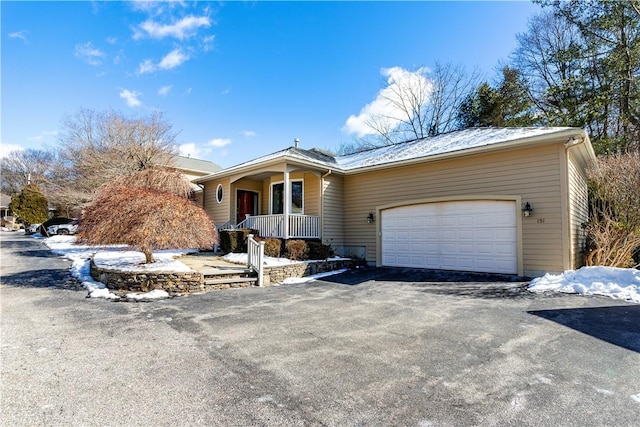 single story home with covered porch and a garage