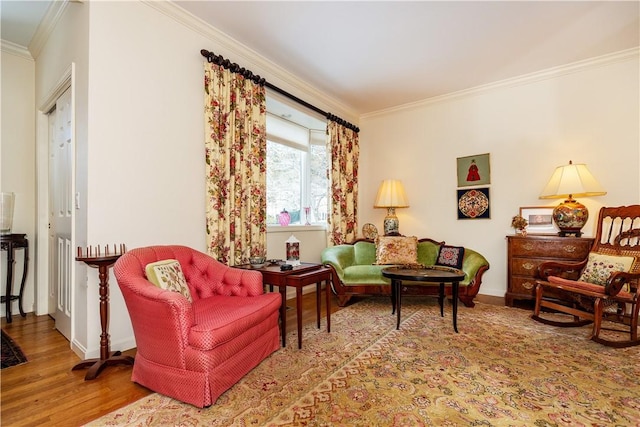 living area featuring crown molding and wood-type flooring