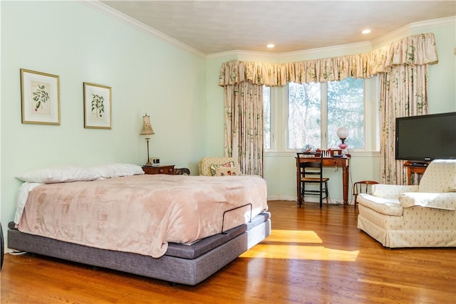 bedroom with hardwood / wood-style flooring and ornamental molding