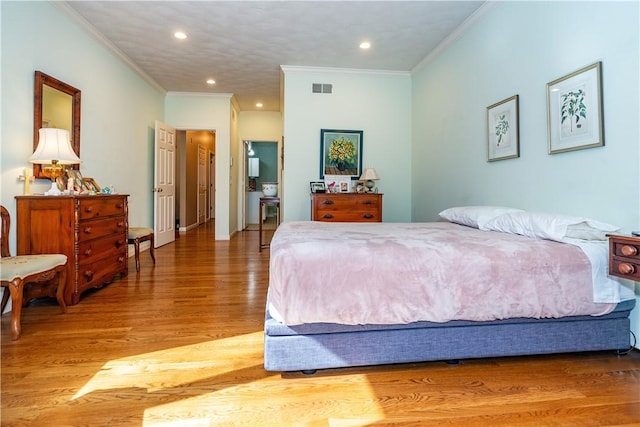 bedroom featuring ornamental molding and hardwood / wood-style floors