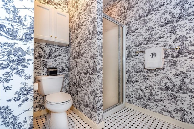 bathroom featuring tile patterned floors, an enclosed shower, and toilet