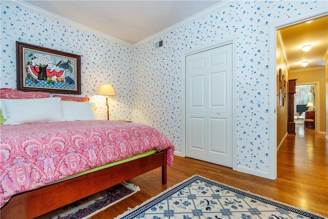 bedroom featuring hardwood / wood-style floors and ornamental molding