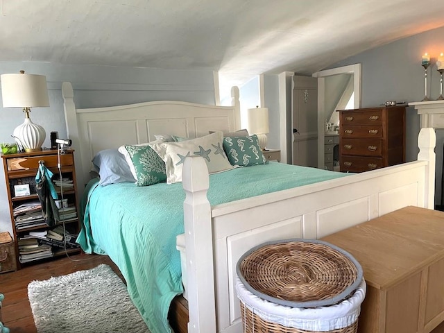 bedroom featuring dark wood-type flooring and vaulted ceiling