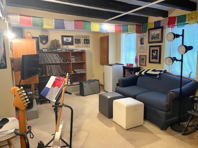 interior space with beam ceiling, carpet flooring, and a healthy amount of sunlight