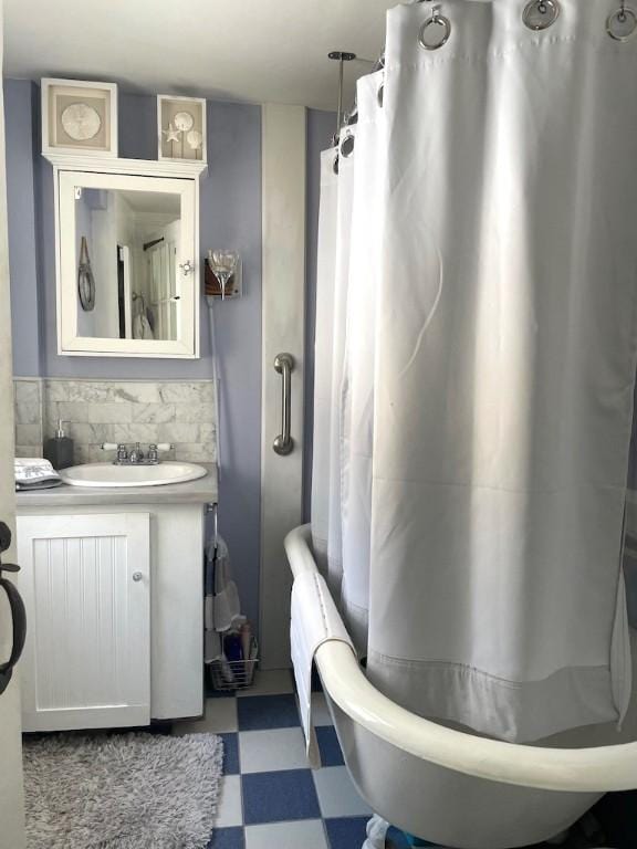 bathroom with sink, shower / bath combo, and decorative backsplash