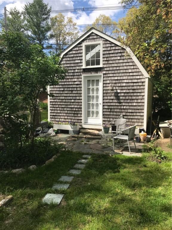 view of outdoor structure featuring a lawn