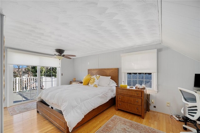 bedroom with ceiling fan, light wood-type flooring, access to outside, and a textured ceiling