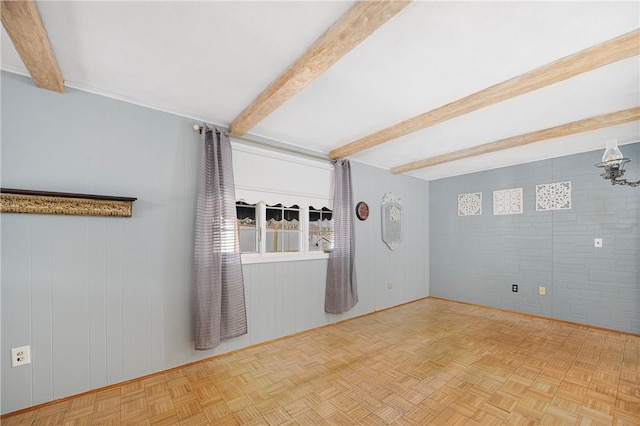 empty room with beamed ceiling and parquet floors