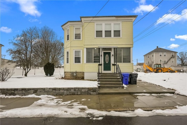 view of front of house with entry steps and fence