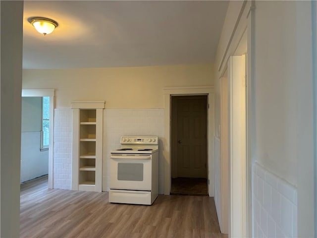 kitchen featuring light wood-style floors and white range with electric cooktop