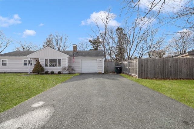 view of front of home featuring a front lawn and a garage