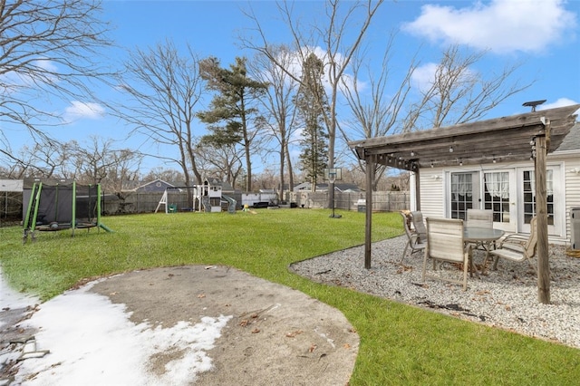 view of yard featuring a playground, a trampoline, and a patio area