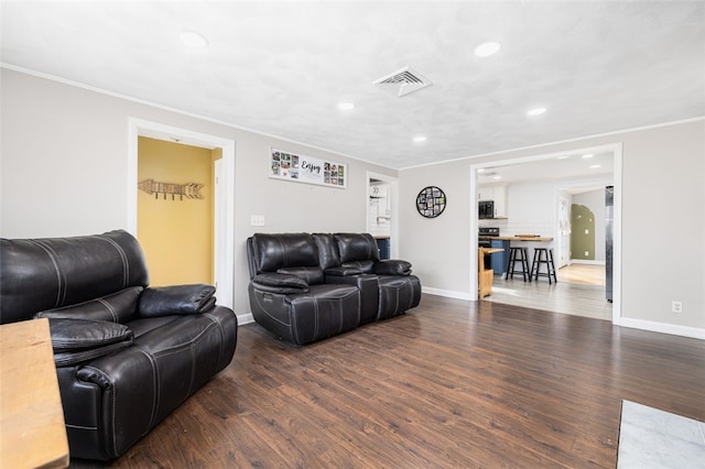 living room featuring crown molding and dark hardwood / wood-style flooring