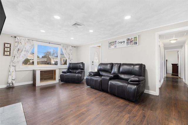 living room featuring ornamental molding and dark hardwood / wood-style flooring