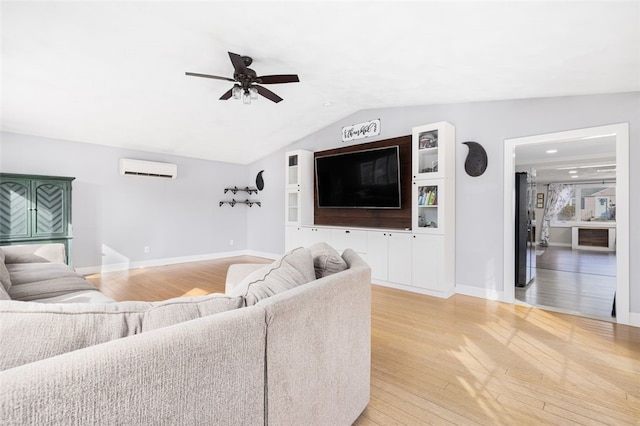 living room with lofted ceiling, light hardwood / wood-style flooring, ceiling fan, and a wall mounted air conditioner