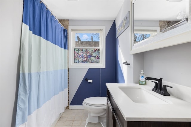 bathroom featuring vanity, toilet, and tile patterned floors