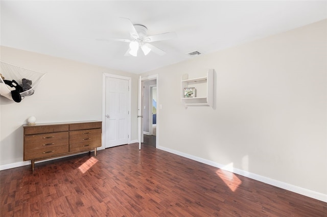 unfurnished bedroom with ceiling fan and dark hardwood / wood-style floors